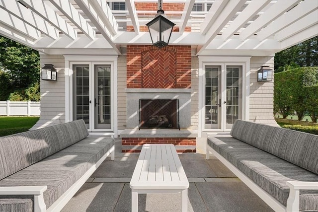 view of patio featuring an outdoor living space with a fireplace and french doors