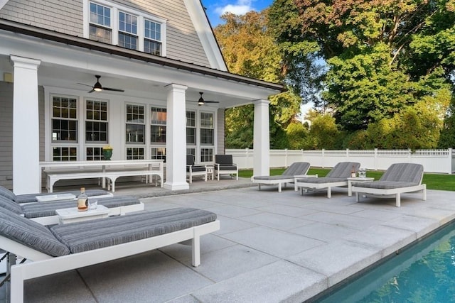view of patio with a fenced in pool, fence, and a ceiling fan