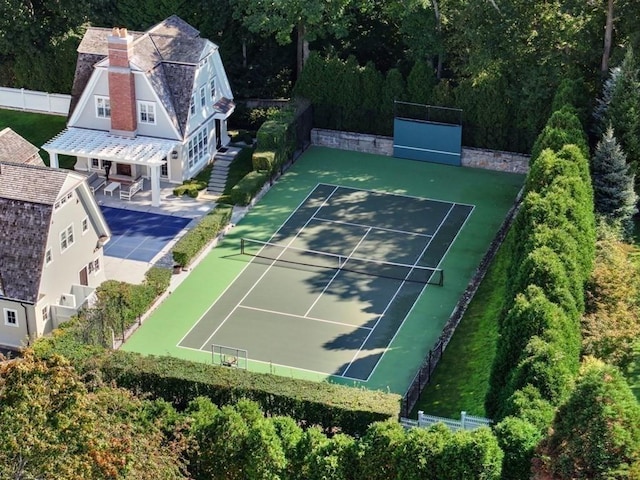 view of tennis court featuring fence