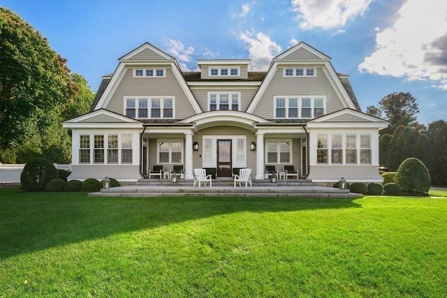 rear view of property with a lawn and a patio