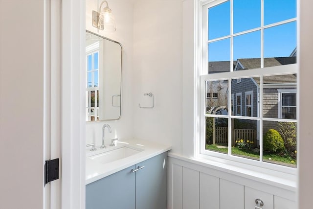 6 Mariner Way, Nantucket, MA 02564 - bathroom featuring a decorative wall, a wainscoted wall, a wealth of natural light, and vanity