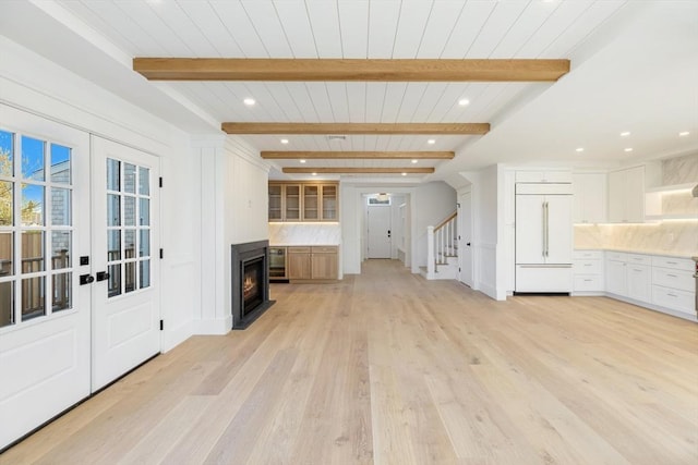 6 Mariner Way, Nantucket, MA 02564 - unfurnished living room featuring stairs, beam ceiling, a warm lit fireplace, recessed lighting, and light wood finished floors