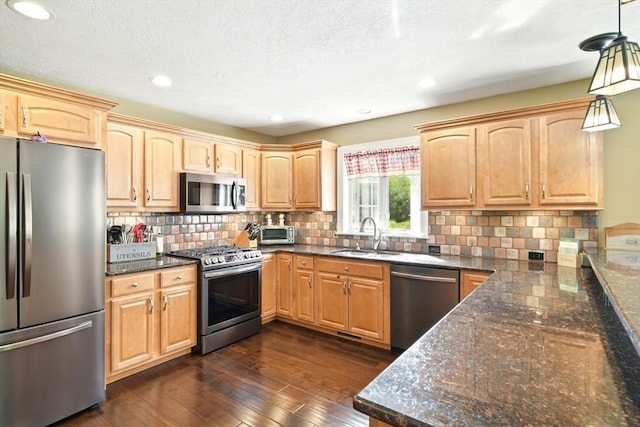 8 Pheasant Run, Belchertown, MA 01007 - kitchen with appliances with stainless steel finishes, a sink, tasteful backsplash, dark wood finished floors, and decorative light fixtures