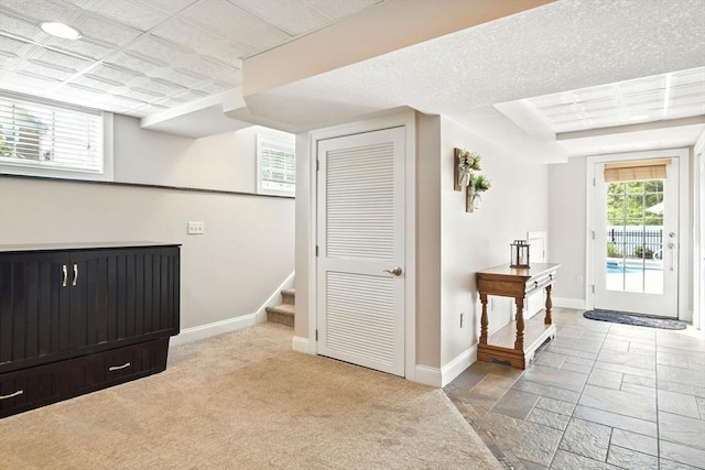 8 Pheasant Run, Belchertown, MA 01007 - below grade area featuring baseboards, light carpet, and stairway
