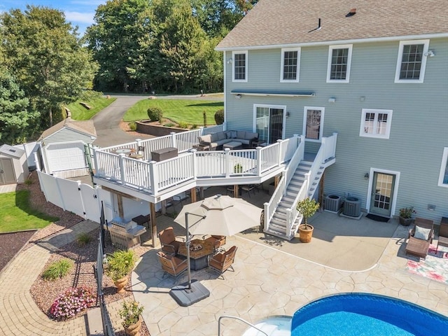 8 Pheasant Run, Belchertown, MA 01007 - back of property with a wooden deck, an outdoor living space with a fire pit, stairs, and outdoor dining area
