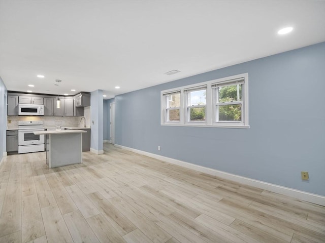 24 Bettys Pond Rd Unit K, Barnstable, MA 02601 - kitchen with white appliances, gray cabinetry, open floor plan, light countertops, and baseboards