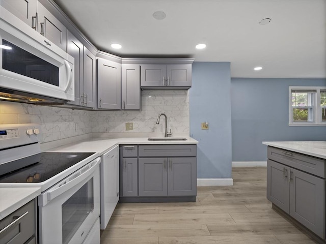 24 Bettys Pond Rd Unit K, Barnstable, MA 02601 - kitchen with white appliances, a sink, gray cabinetry, tasteful backsplash, and recessed lighting