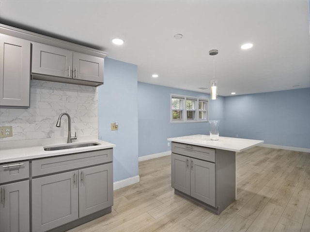 24 Bettys Pond Rd Unit K, Barnstable, MA 02601 - kitchen with gray cabinets, a sink, light countertops, tasteful backsplash, and recessed lighting