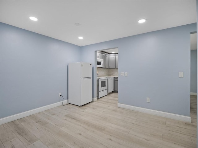 24 Bettys Pond Rd Unit K, Barnstable, MA 02601 - kitchen with white appliances, baseboards, light wood-style flooring, recessed lighting, and light countertops