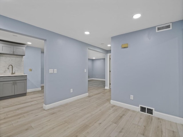 24 Bettys Pond Rd Unit K, Barnstable, MA 02601 - empty room featuring light wood-style floors, recessed lighting, baseboards, and bar with sink