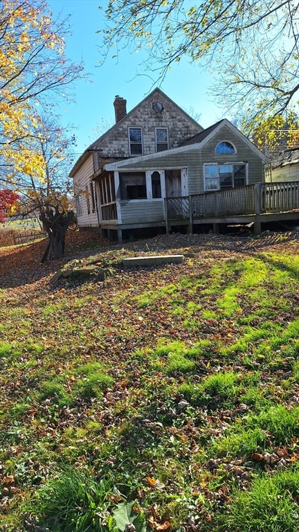 back of house with a wooden deck