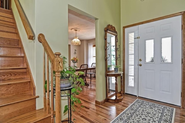 foyer entrance with wood finished floors and stairway