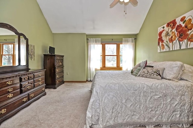 bedroom featuring baseboards, carpet flooring, lofted ceiling, and multiple windows
