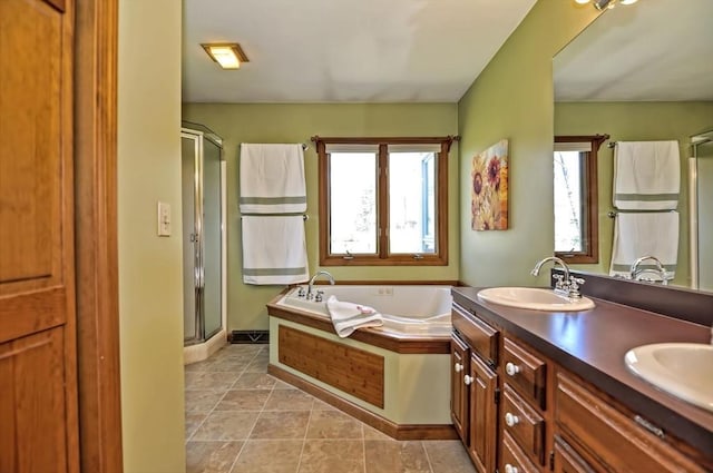 bathroom featuring a sink, double vanity, tile patterned floors, a garden tub, and a stall shower