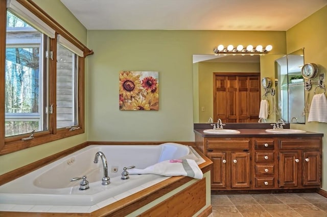 full bathroom with a sink, plenty of natural light, a jetted tub, and double vanity