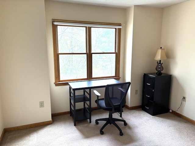 home office with baseboards and light colored carpet
