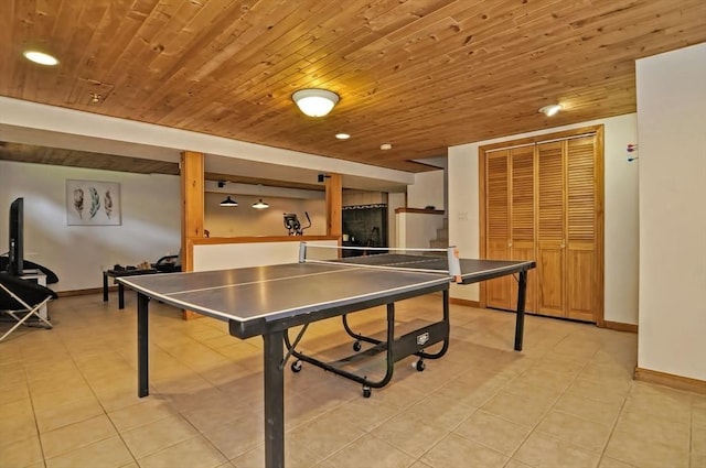 playroom featuring light tile patterned floors, baseboards, and wooden ceiling
