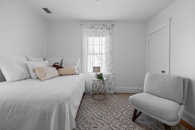 bedroom with visible vents and baseboards