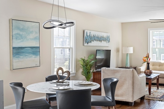 dining area featuring dark wood-type flooring and a chandelier