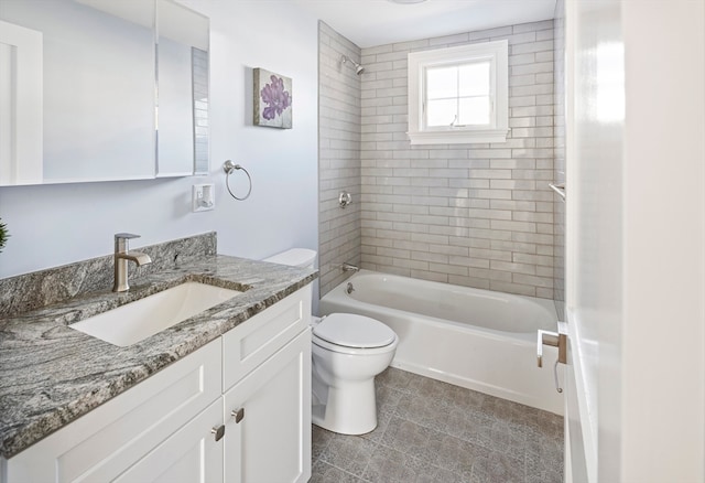 full bathroom featuring tiled shower / bath, toilet, and vanity