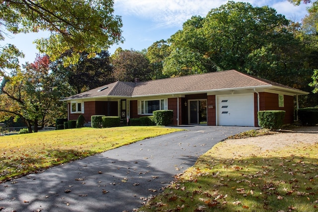 single story home featuring a front yard and a garage