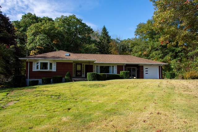 single story home featuring a front yard and a garage