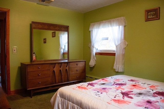 bedroom featuring a baseboard heating unit and carpet floors