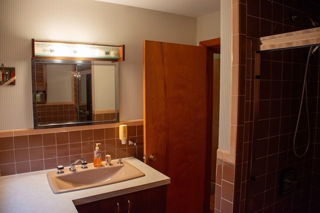 bathroom with vanity, backsplash, and a tile shower