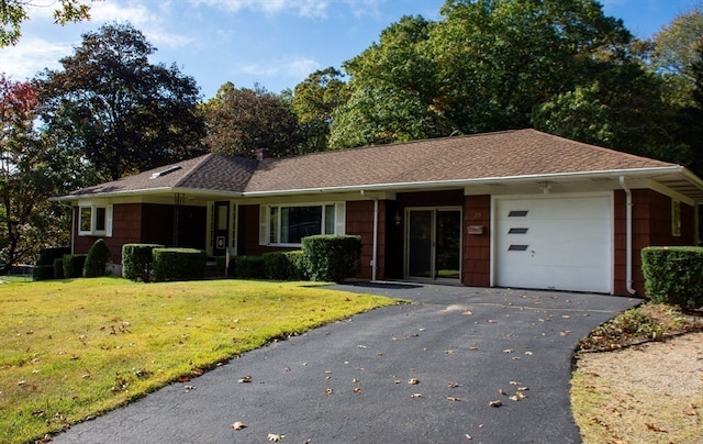 ranch-style home featuring a front yard and a garage