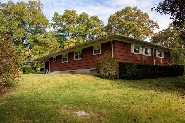 view of home's exterior with a yard