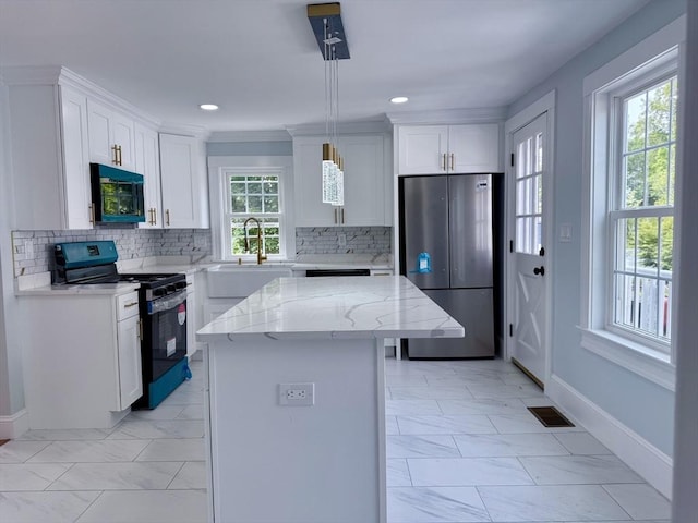 61 Poplar St, Danvers, MA 01923 - kitchen featuring black appliances, light marble finish floors, a center island, light stone counters, and recessed lighting