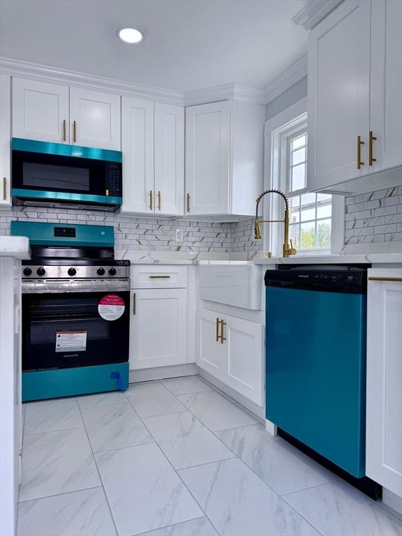 61 Poplar St, Danvers, MA 01923 - kitchen featuring stainless steel appliances, light countertops, ornamental molding, white cabinetry, and decorative backsplash