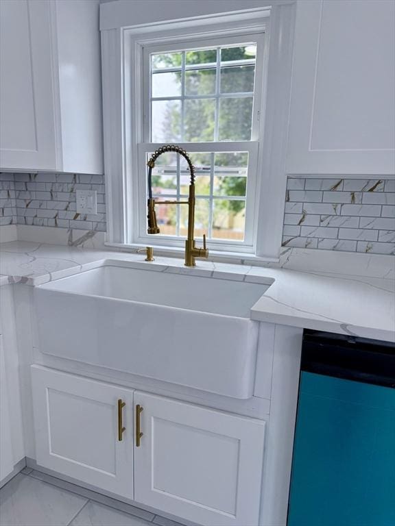61 Poplar St, Danvers, MA 01923 - kitchen featuring a sink, dishwashing machine, white cabinets, light stone counters, and tasteful backsplash