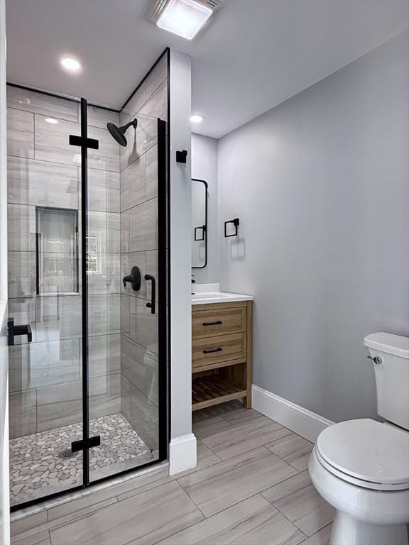 61 Poplar St, Danvers, MA 01923 - full bathroom with toilet, vanity, a shower stall, baseboards, and recessed lighting