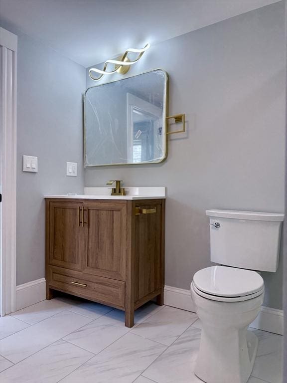 61 Poplar St, Danvers, MA 01923 - bathroom featuring baseboards, toilet, vanity, and marble finish flooring