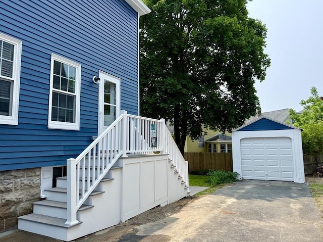 61 Poplar St, Danvers, MA 01923 - view of side of home featuring an outdoor structure, asphalt driveway, stairs, and a detached garage