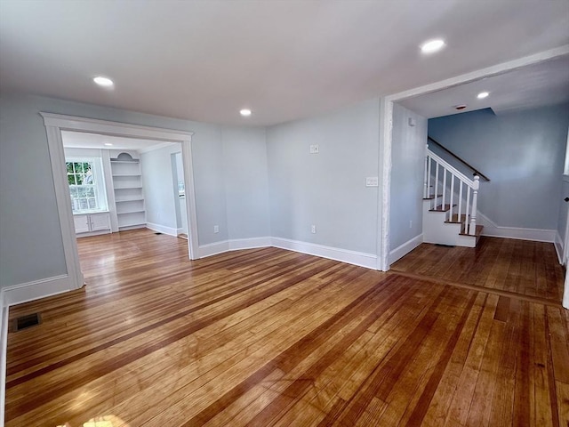61 Poplar St, Danvers, MA 01923 - unfurnished room featuring wood-type flooring, stairway, baseboards, recessed lighting, and built in shelves