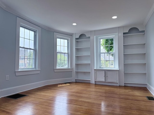 61 Poplar St, Danvers, MA 01923 - spare room featuring ornamental molding, wood finished floors, built in shelves, baseboards, and recessed lighting