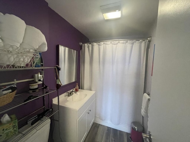 full bathroom with vanity, shower / tub combo, and wood finished floors