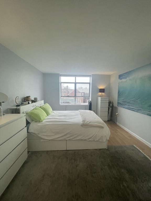 bedroom with baseboards and wood finished floors