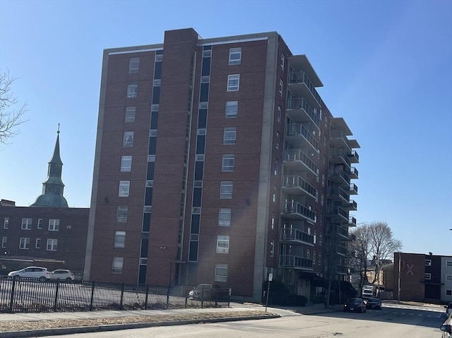 view of building exterior with fence