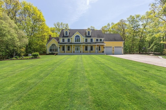 27 Sullivan Blvd, Oxford, MA 01540 - colonial home featuring a garage, a porch, driveway, and a front lawn