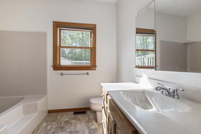 27 Sullivan Blvd, Oxford, MA 01540 - full bathroom featuring toilet, baseboards, healthy amount of natural light, and a tub