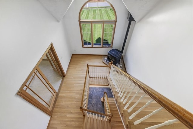 27 Sullivan Blvd, Oxford, MA 01540 - staircase featuring wood finished floors, a wood stove, vaulted ceiling, and baseboards