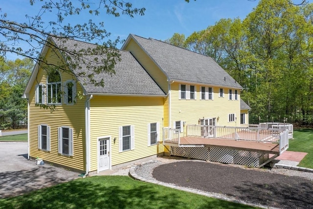 27 Sullivan Blvd, Oxford, MA 01540 - rear view of house with a shingled roof, a wooden deck, a lawn, and driveway
