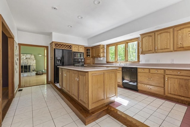 27 Sullivan Blvd, Oxford, MA 01540 - kitchen featuring black appliances, light countertops, a sink, a center island, and brown cabinets