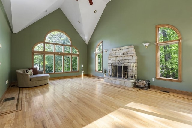 27 Sullivan Blvd, Oxford, MA 01540 - unfurnished living room featuring wood finished floors, high vaulted ceiling, ceiling fan, a stone fireplace, and baseboards