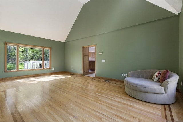 27 Sullivan Blvd, Oxford, MA 01540 - living area with high vaulted ceiling, baseboards, and light wood-style floors