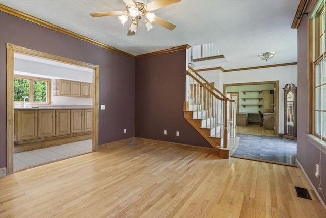27 Sullivan Blvd, Oxford, MA 01540 - empty room with light wood-style floors, stairs, baseboards, ornamental molding, and a ceiling fan