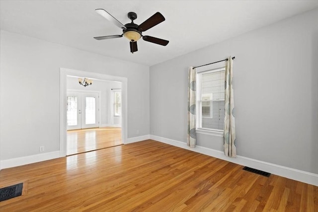 unfurnished room with ceiling fan, wood-type flooring, and french doors